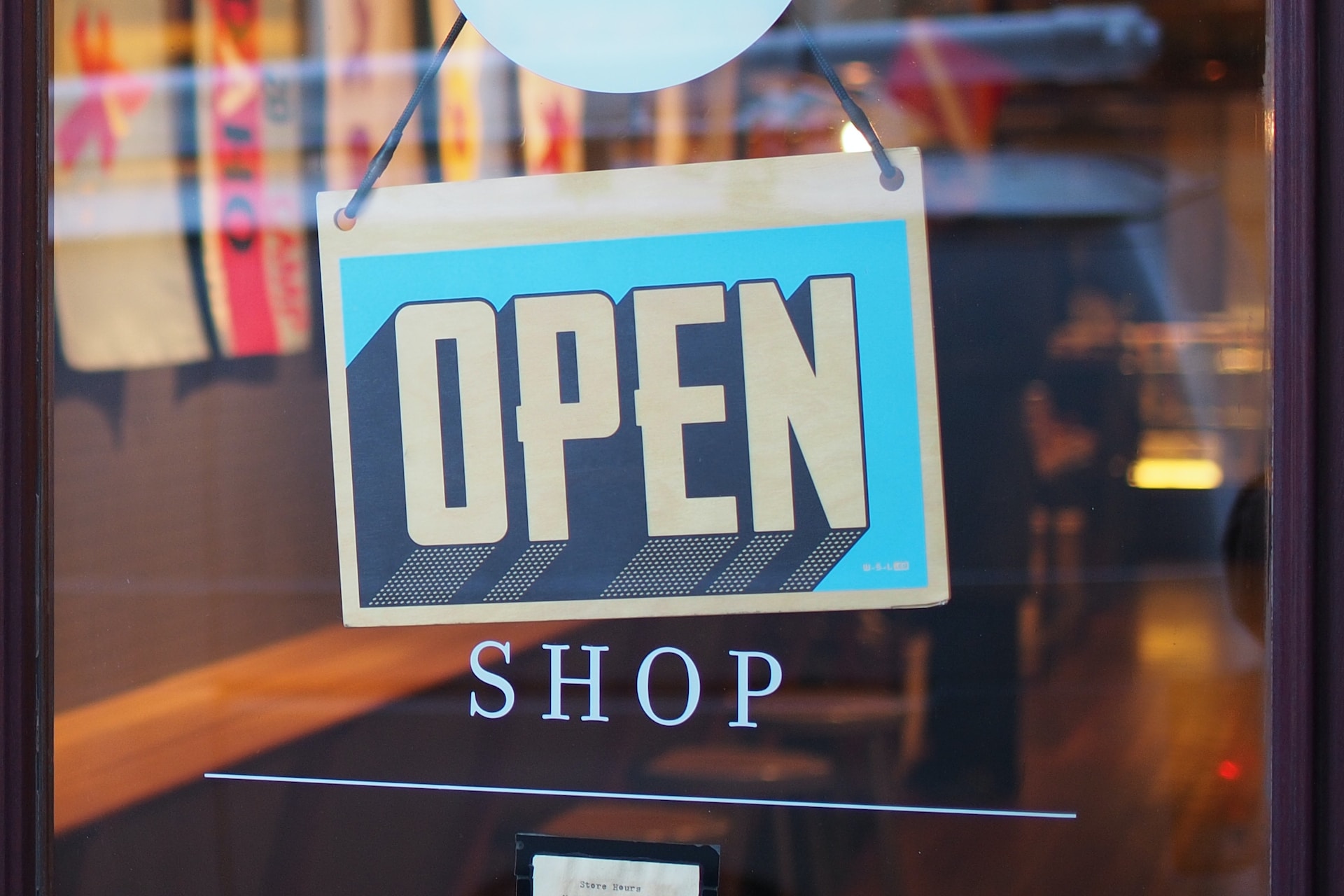 A shop door with the sign that says open.